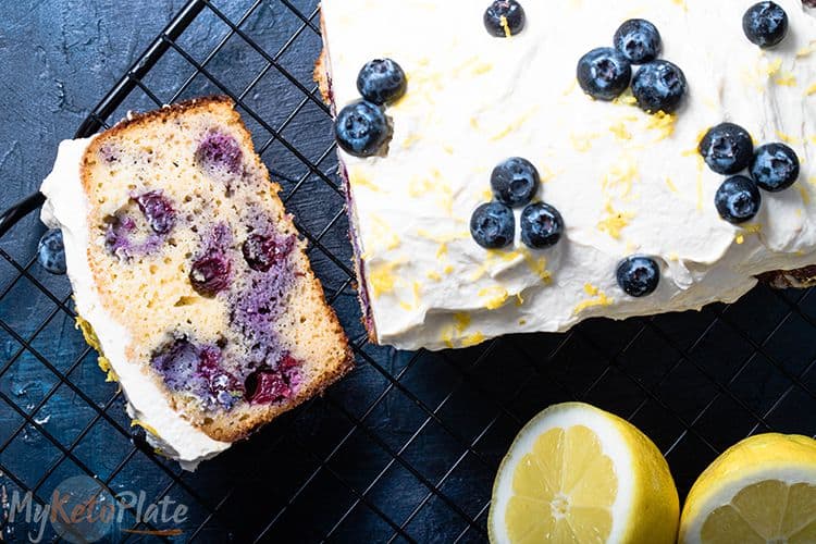 keto blueberry bread and slice on a black background and lemon