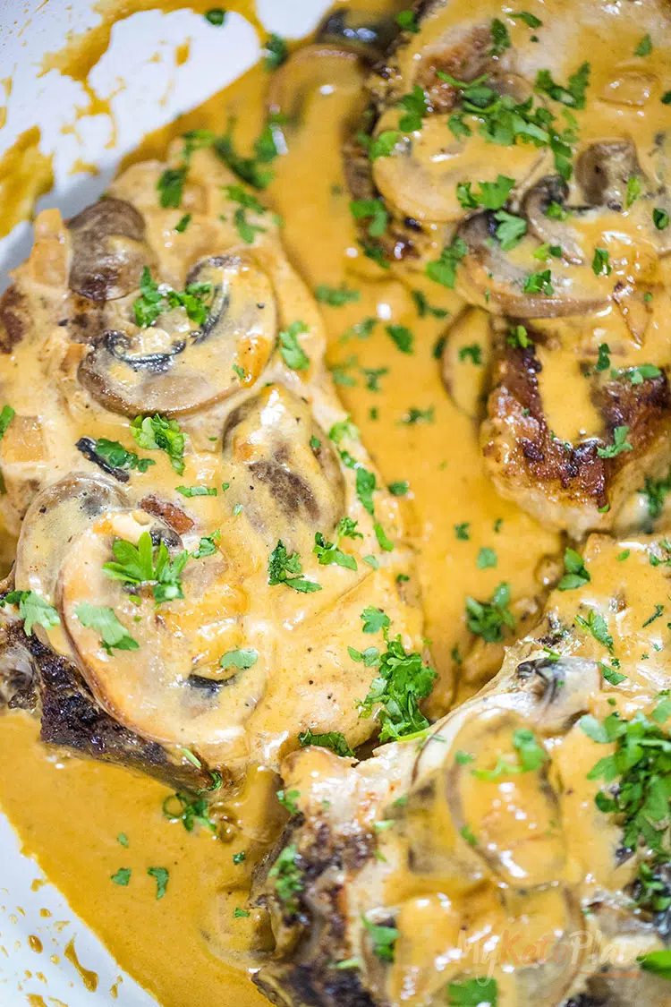 Garlic Mushroom Pork Chops is ready in under 30 minutes; it’s the best one-pan pork chop keto recipe. The pork chops are seared to perfection then smothered is a super creamy garlic-infused mushroom sauce. #ketorecipes #porkchops #creamysauce #lowcarb