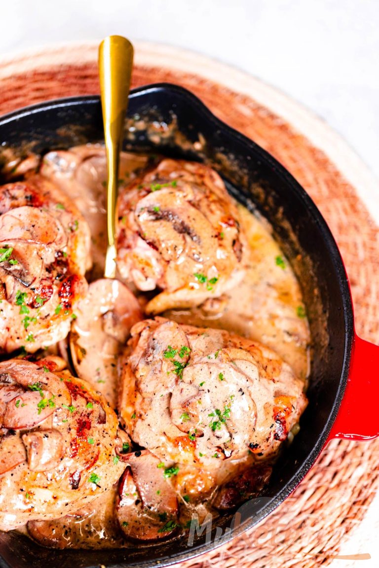 creamy chicken thighs with mushroom sauce in the skillet
