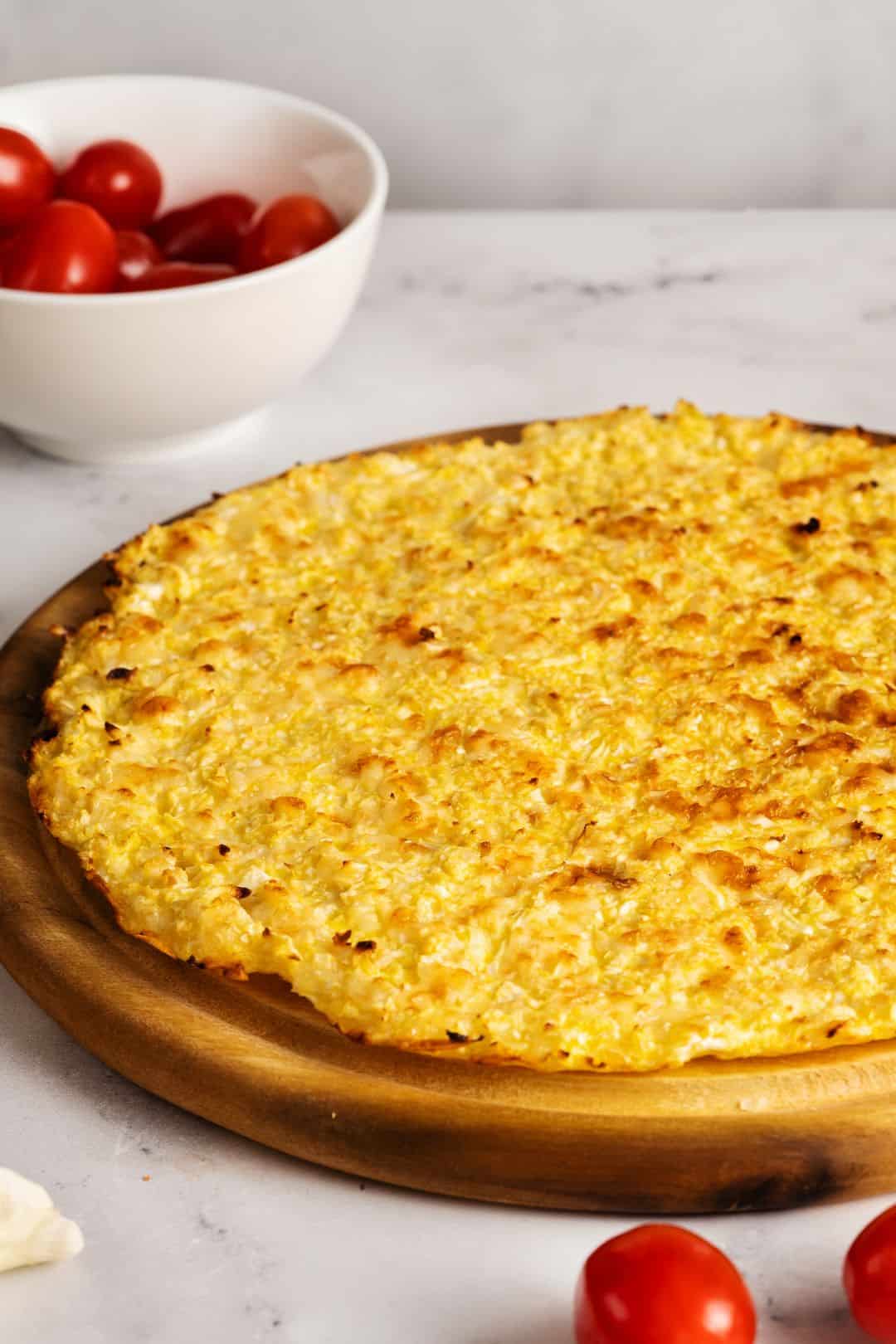 A beautifully baked cauliflower pizza crust, golden and firm, perfect for adding toppings.