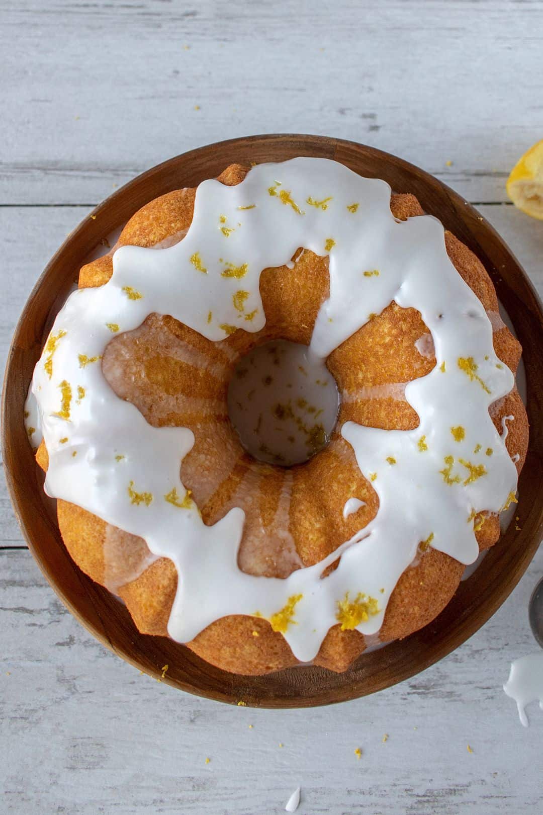 Overhead shot of a golden low-carb bundt cake with white icing drizzled on top.