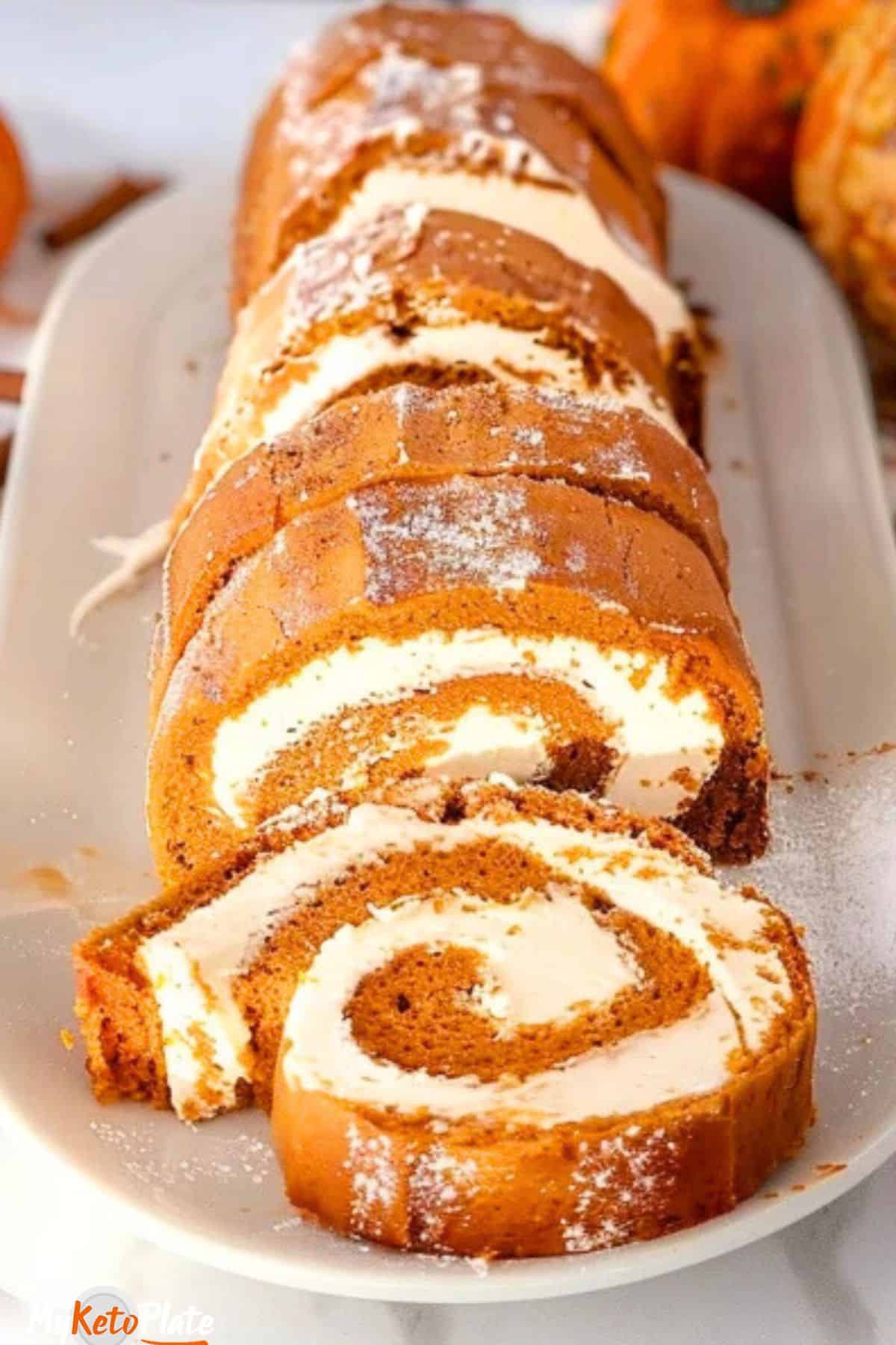 Finished pumpkin roll cake with dusting of cinnamon