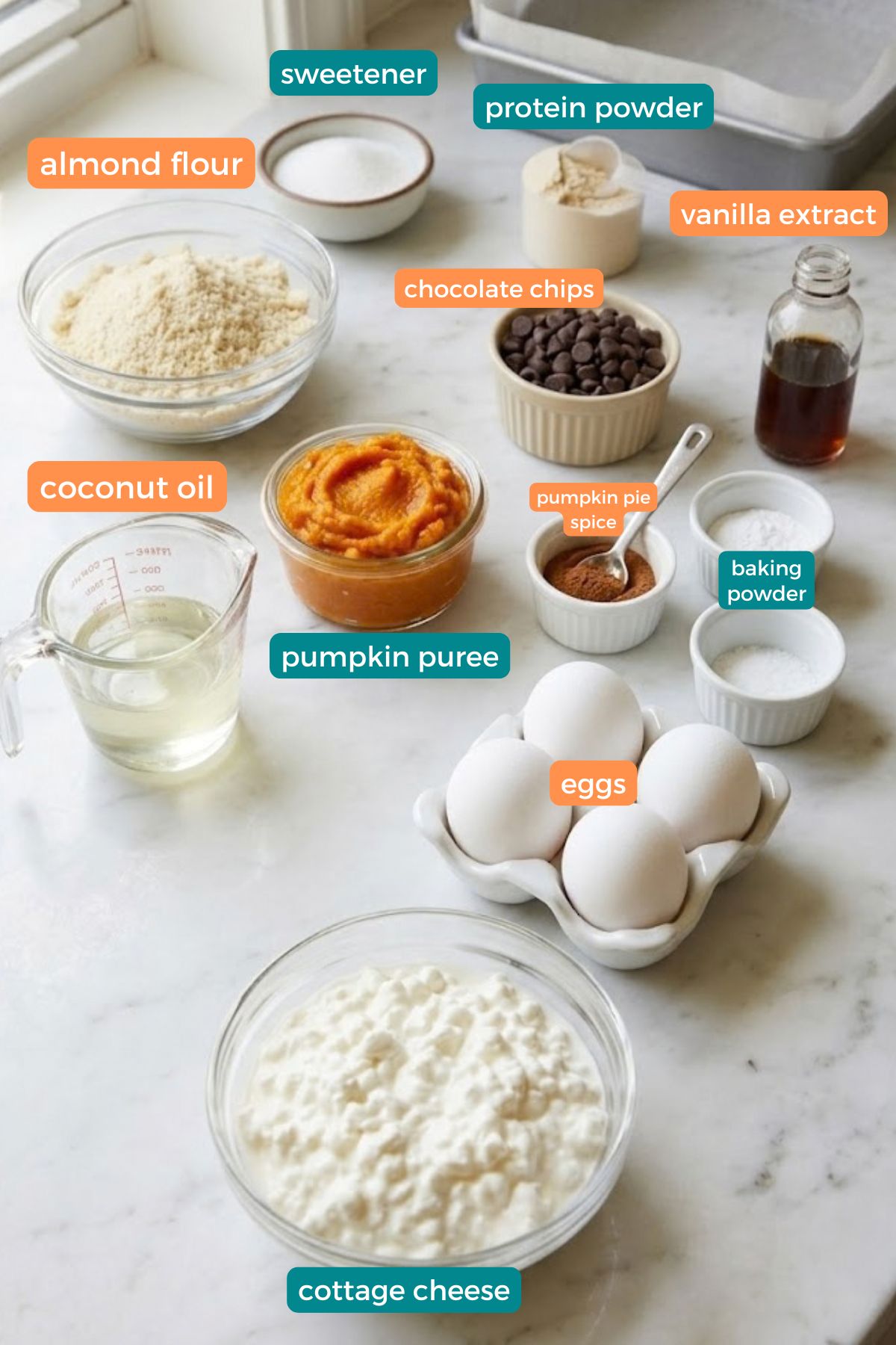 High-Protein Cottage Cheese Pumpkin Bars 4 Ingredients for High-Protein Cottage Cheese Pumpkin Bars, including cottage cheese, pumpkin puree, eggs, almond flour, protein powder, sweetener, chocolate chips, and pumpkin spice.