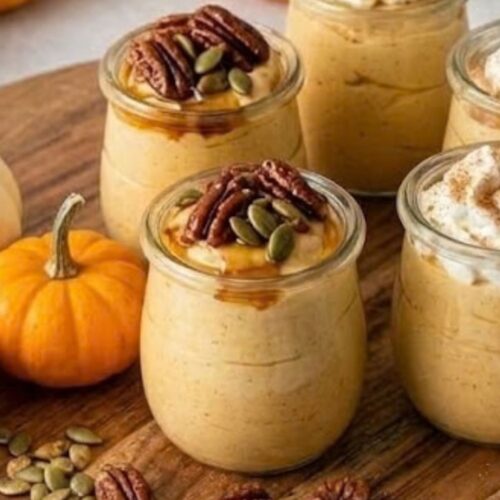 Cottage Cheese Pumpkin Mousse 5 Creamy cottage cheese pumpkin mousse served in small jars with pecans, pumpkin seeds, and whipped cream for a fall dessert.