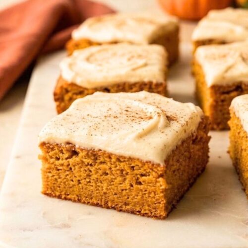 High-Protein Cottage Cheese Pumpkin Bars 7 Close-up of a soft High-Protein Cottage Cheese Pumpkin Bar with cream cheese frosting and pumpkin spice on top.